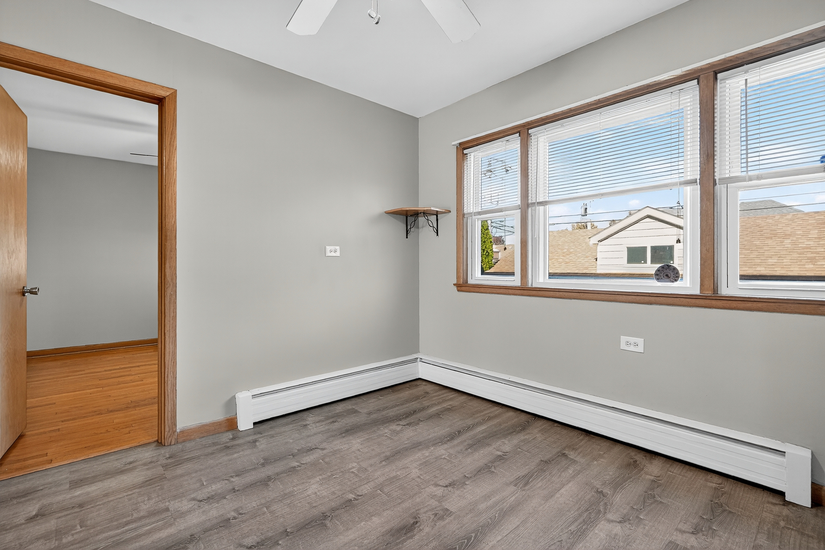 6408 West Raven Street, Unit 1 Chicago, IL 60631 - Photo 13 of 24 an empty room with wooden floor and windows