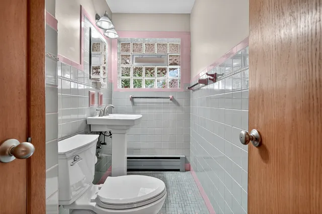 a view of a room with wooden floor and a bathroom