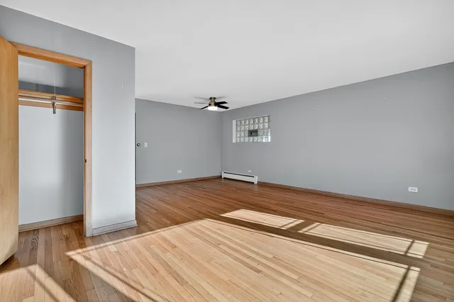 a view of an empty room with wooden floor
