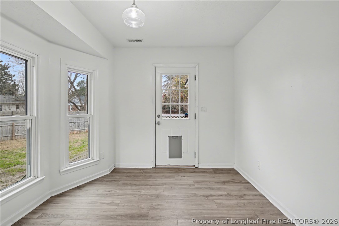 5073 Linton Hall Road Fayetteville, NC 28311 - Photo 11 of 32 an empty room with wooden floor and windows