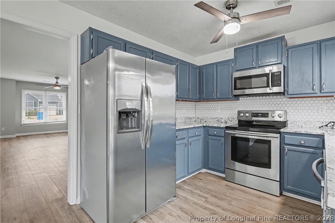 5073 Linton Hall Road Fayetteville, NC 28311 - Photo 15 of 32 a kitchen with stainless steel appliances granite countertop a stove a refrigerator and a microwave