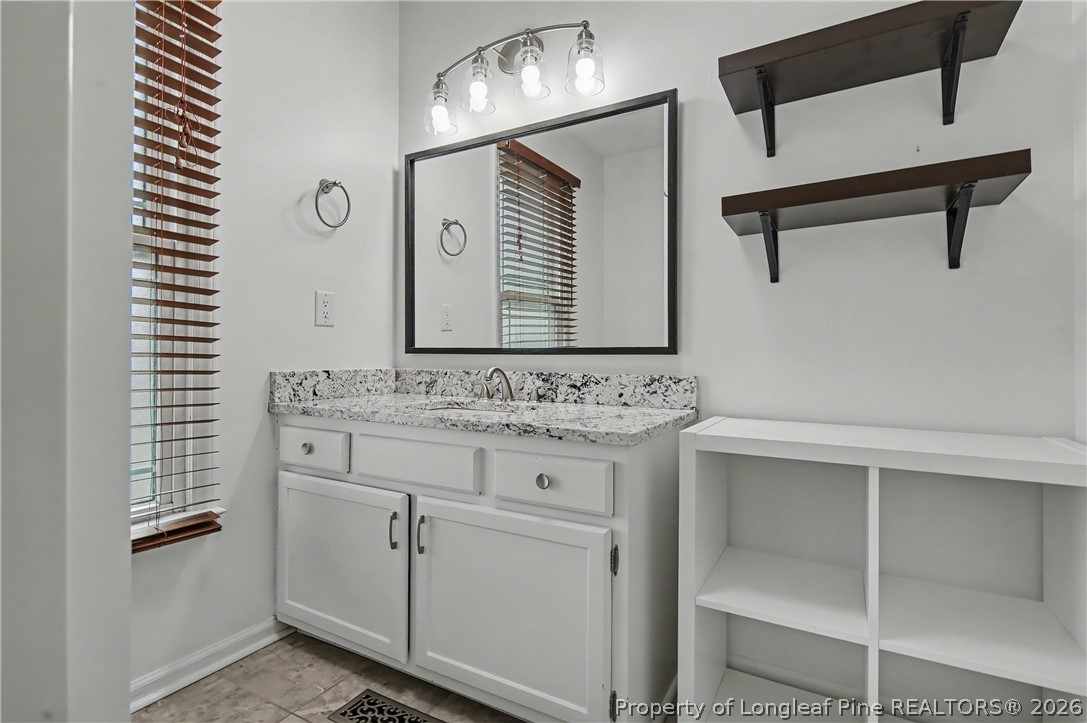 5073 Linton Hall Road Fayetteville, NC 28311 - Photo 19 of 32 a bathroom with a sink and a mirror