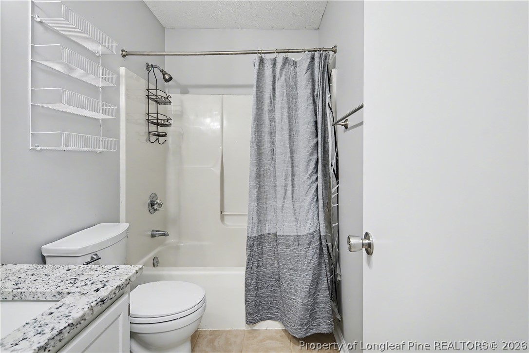 5073 Linton Hall Road Fayetteville, NC 28311 - Photo 24 of 32 a bathroom with a granite countertop sink toilet and shower
