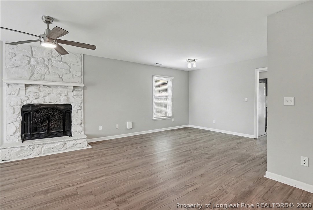 5073 Linton Hall Road Fayetteville, NC 28311 - Photo 5 of 32 a view of an empty room with wooden floor fireplace and a window
