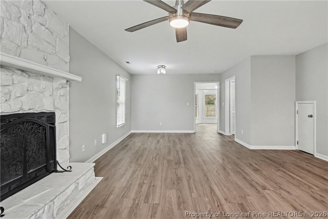 5073 Linton Hall Road Fayetteville, NC 28311 - Photo 6 of 32 wooden floor in an empty room with a fireplace