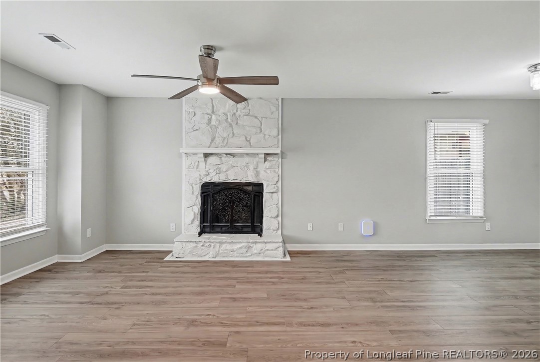 5073 Linton Hall Road Fayetteville, NC 28311 - Photo 8 of 32 a view of empty room with wooden floor and fireplace