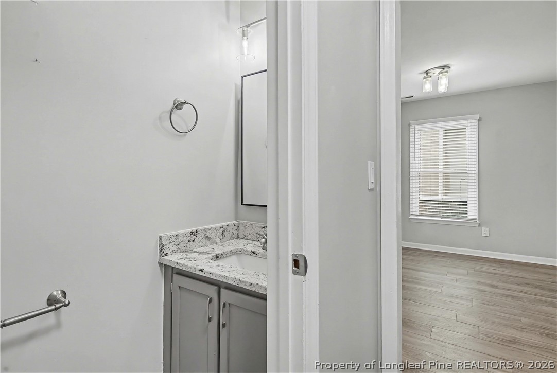 5073 Linton Hall Road Fayetteville, NC 28311 - Photo 9 of 32 a bathroom with a granite countertop sink and a mirror