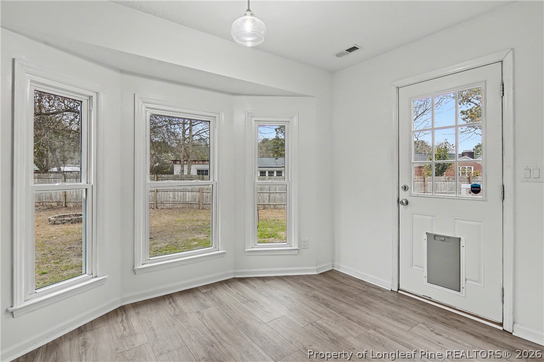 5073 Linton Hall Road Fayetteville, NC 28311 - Photo 10 of 32 a view of an empty room with window and wooden floor