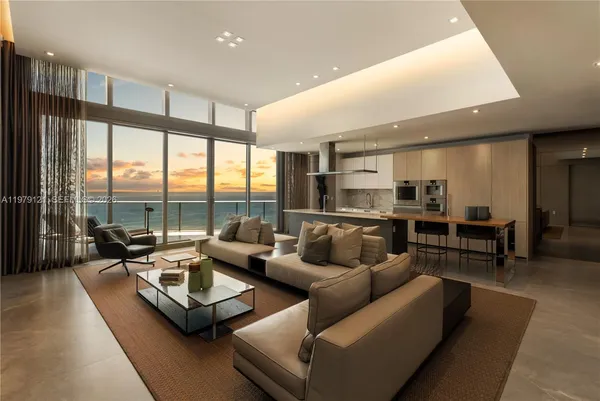 a living room with furniture and large windows