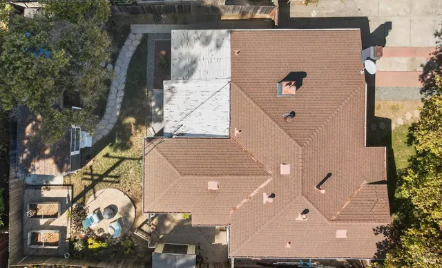 an aerial view of a house with a yard