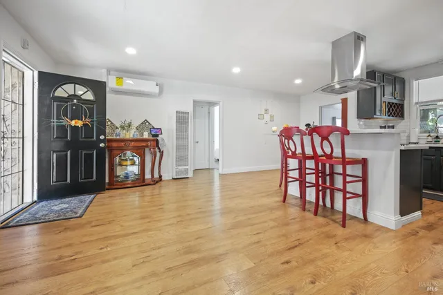 a view of a kitchen with furniture and a ceiling fan