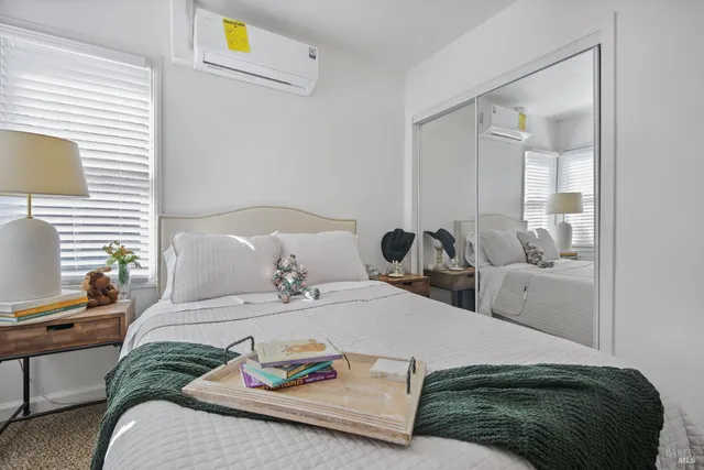 a bedroom with a bed and window