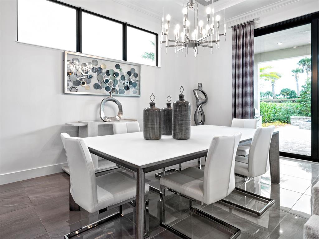 8146 Southwest Vanita Way Port St. Lucie, FL 34987 - Photo 14 of 53 a view of a dining room with furniture a chandelier and window