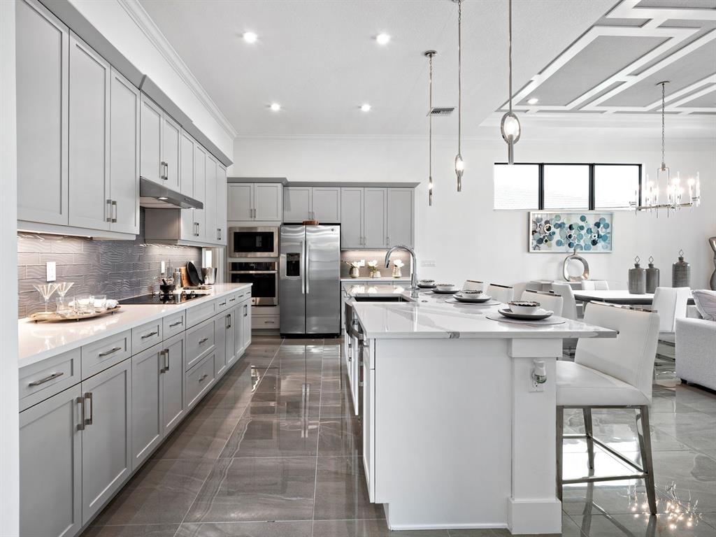 8146 Southwest Vanita Way Port St. Lucie, FL 34987 - Photo 17 of 53 a kitchen with kitchen island granite countertop a sink counter top space appliances and cabinets