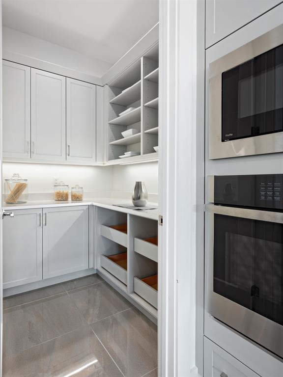 8146 Southwest Vanita Way Port St. Lucie, FL 34987 - Photo 20 of 53 a kitchen with white cabinets and oven