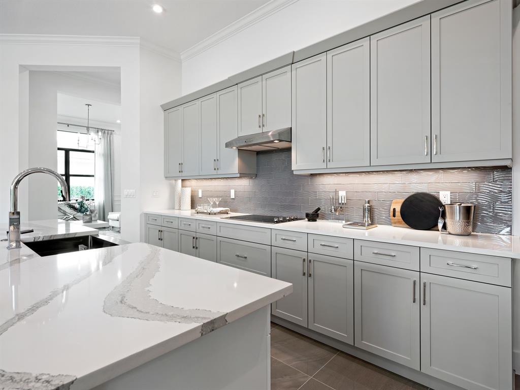 8146 Southwest Vanita Way Port St. Lucie, FL 34987 - Photo 21 of 53 a kitchen with granite countertop white cabinets and white appliances