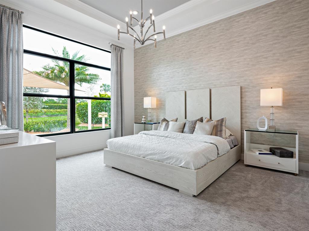 8146 Southwest Vanita Way Port St. Lucie, FL 34987 - Photo 23 of 53 a spacious bedroom with a large bed and a chandelier