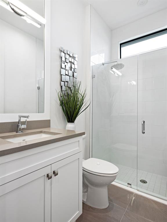 8146 Southwest Vanita Way Port St. Lucie, FL 34987 - Photo 25 of 53 a bathroom with a sink a toilet and shower