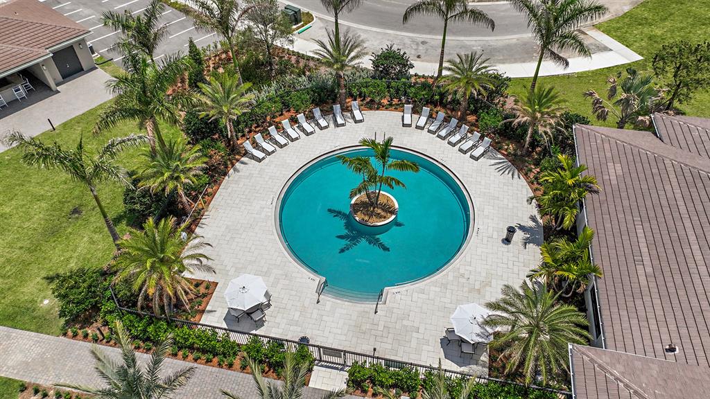 8146 Southwest Vanita Way Port St. Lucie, FL 34987 - Photo 47 of 53 an aerial view of a swimming pool with outdoor seating and yard