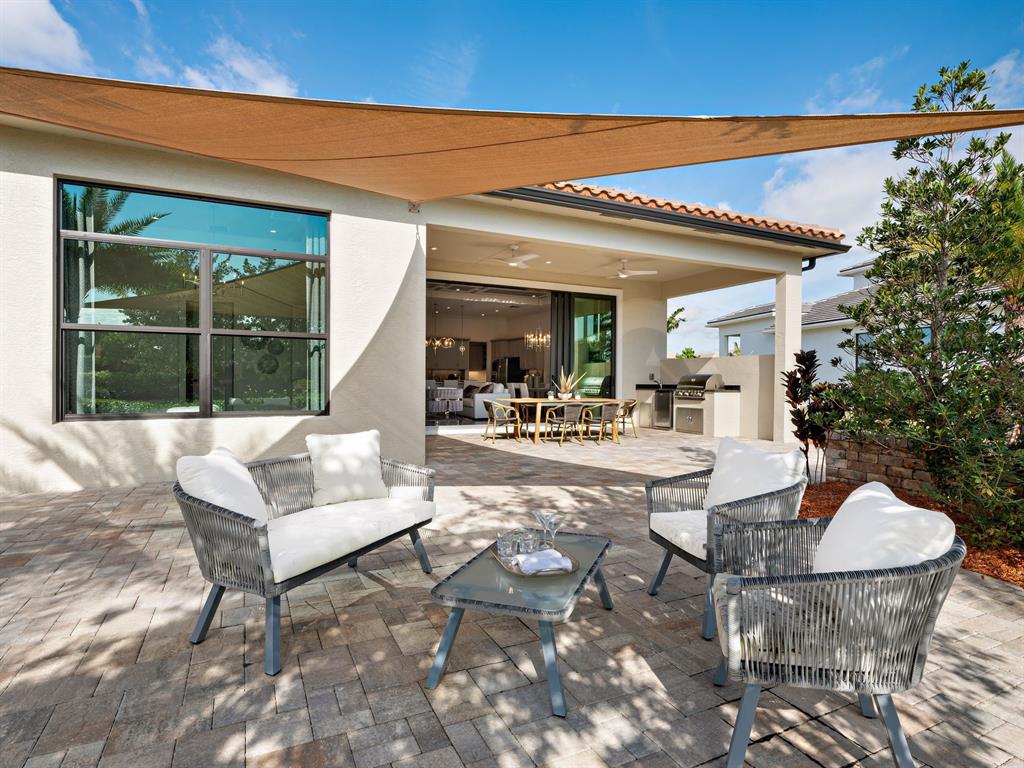 8146 Southwest Vanita Way Port St. Lucie, FL 34987 - Photo 5 of 53 a view of a patio with couches table and chairs and potted plants