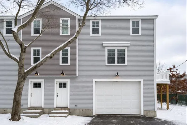 a front view of a house with garage