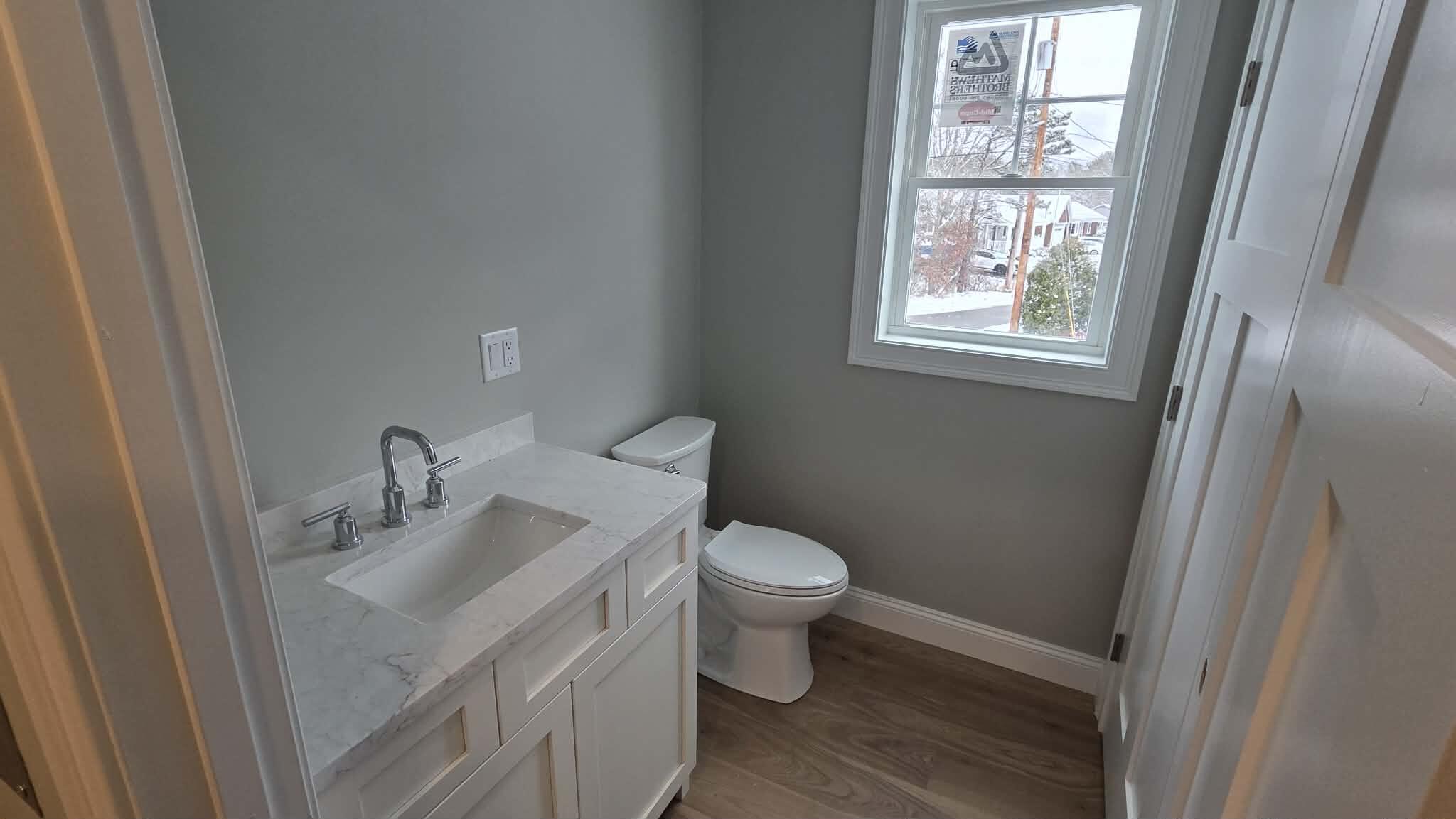 46 B Holt Road Bourne, MA 02532 - Photo 13 of 14 a bathroom with a sink toilet and a window