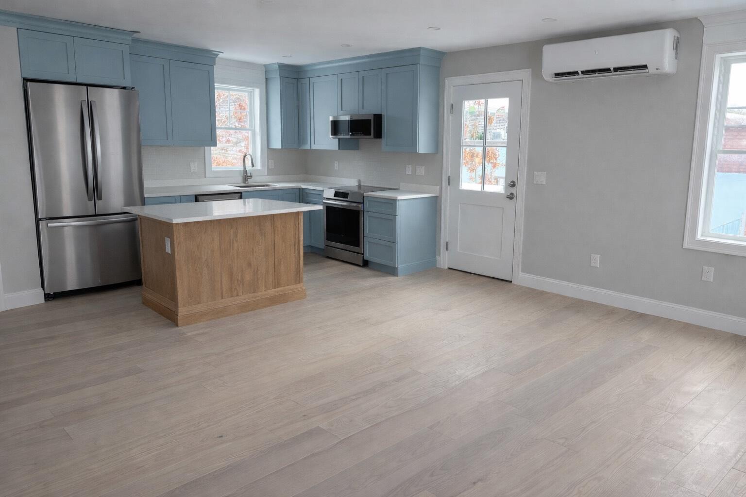 46 B Holt Road Bourne, MA 02532 - Photo 7 of 14 a kitchen with stainless steel appliances granite countertop a stove a refrigerator and a sink