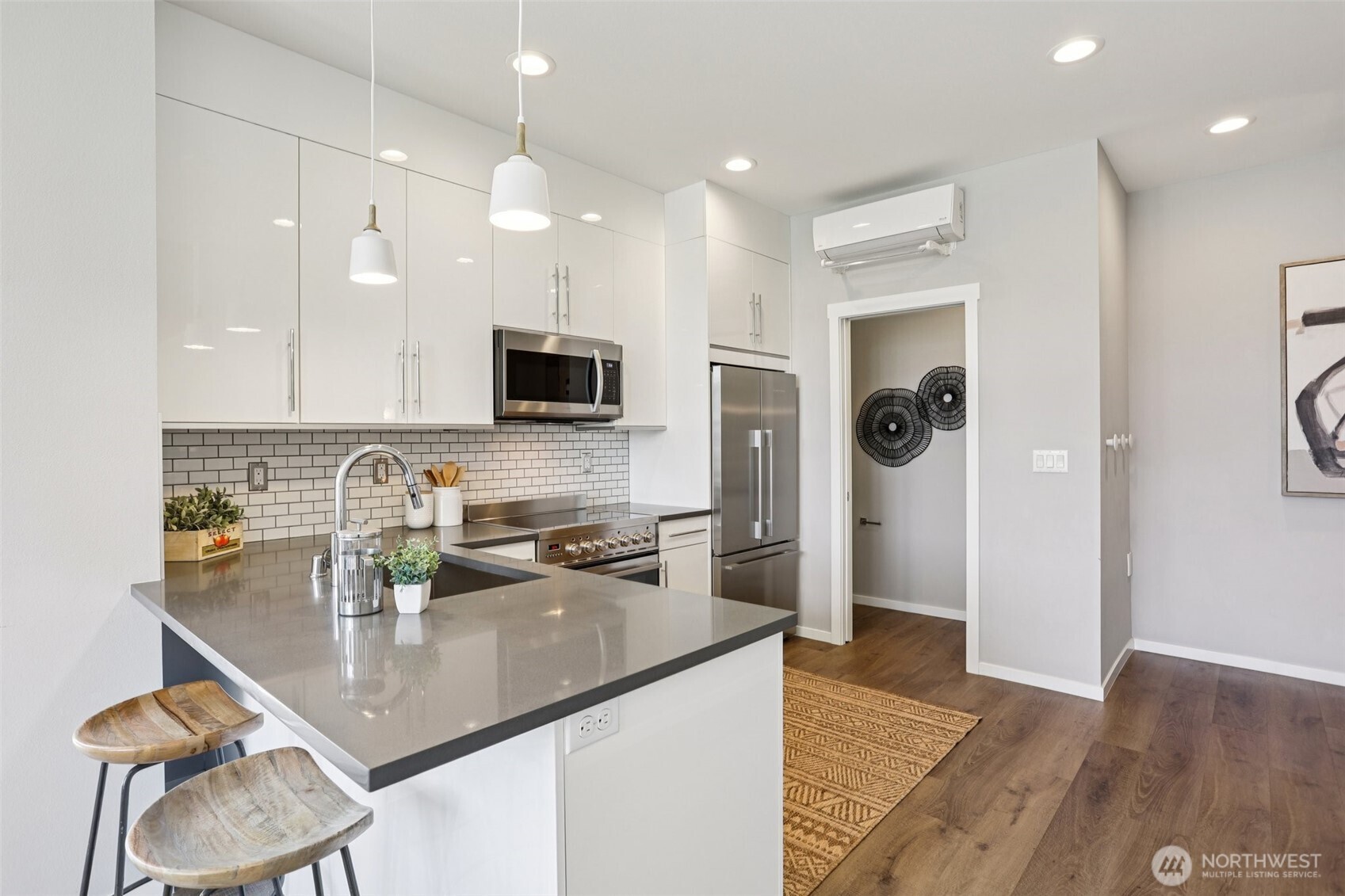 5017 Delridge Way Southwest, Unit A Seattle, WA 98106 - Photo 11 of 26 a kitchen with stainless steel appliances granite countertop a sink refrigerator and cabinets