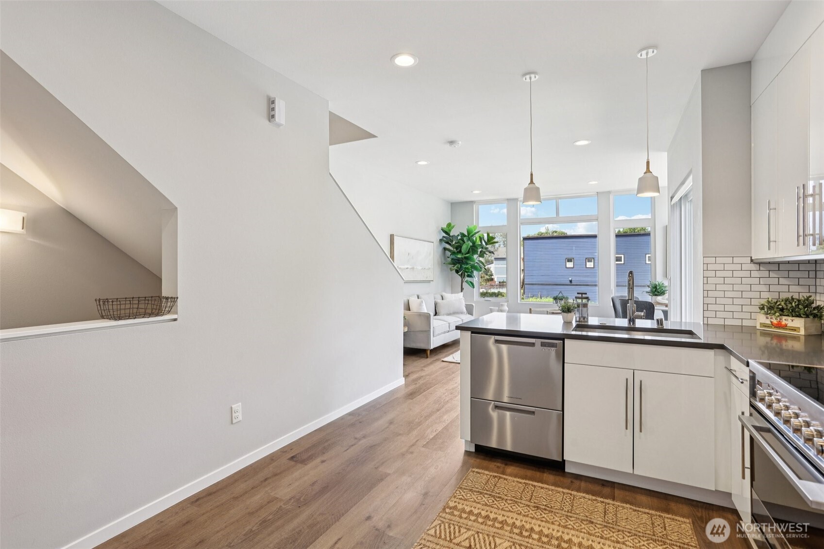 5017 Delridge Way Southwest, Unit A Seattle, WA 98106 - Photo 12 of 26 a kitchen with stainless steel appliances a sink stove and cabinets