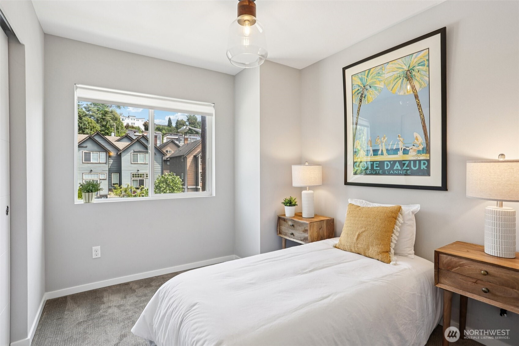 5017 Delridge Way Southwest, Unit A Seattle, WA 98106 - Photo 15 of 26 a bedroom with a bed and a painting on the wall