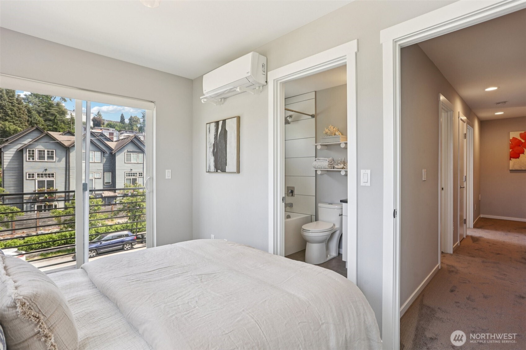 5017 Delridge Way Southwest, Unit A Seattle, WA 98106 - Photo 18 of 26 a bedroom with a bed and a chandelier