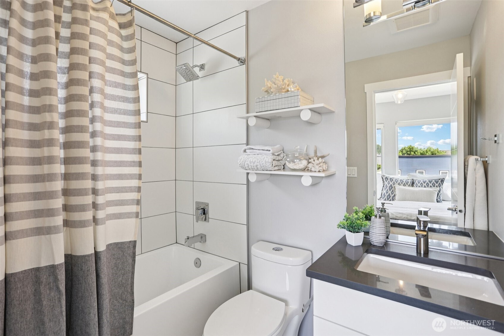 5017 Delridge Way Southwest, Unit A Seattle, WA 98106 - Photo 20 of 26 a bathroom with a granite countertop sink a toilet and shower