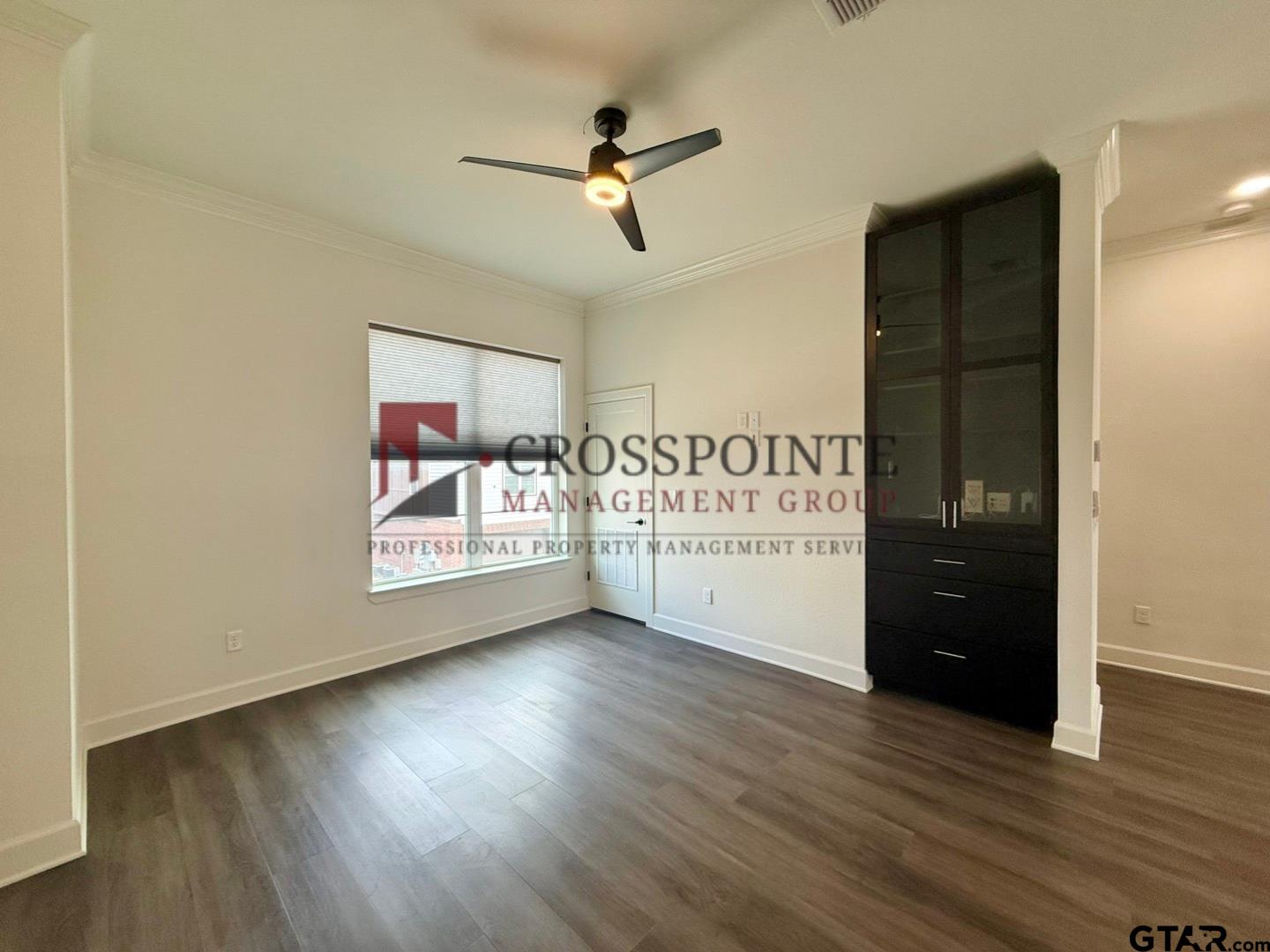 548 West Erwin Street Tyler, TX 75702 - Photo 9 of 27 a view of a room with wooden floor and ceiling fan