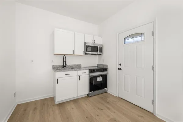 a kitchen with a sink and a stove top oven
