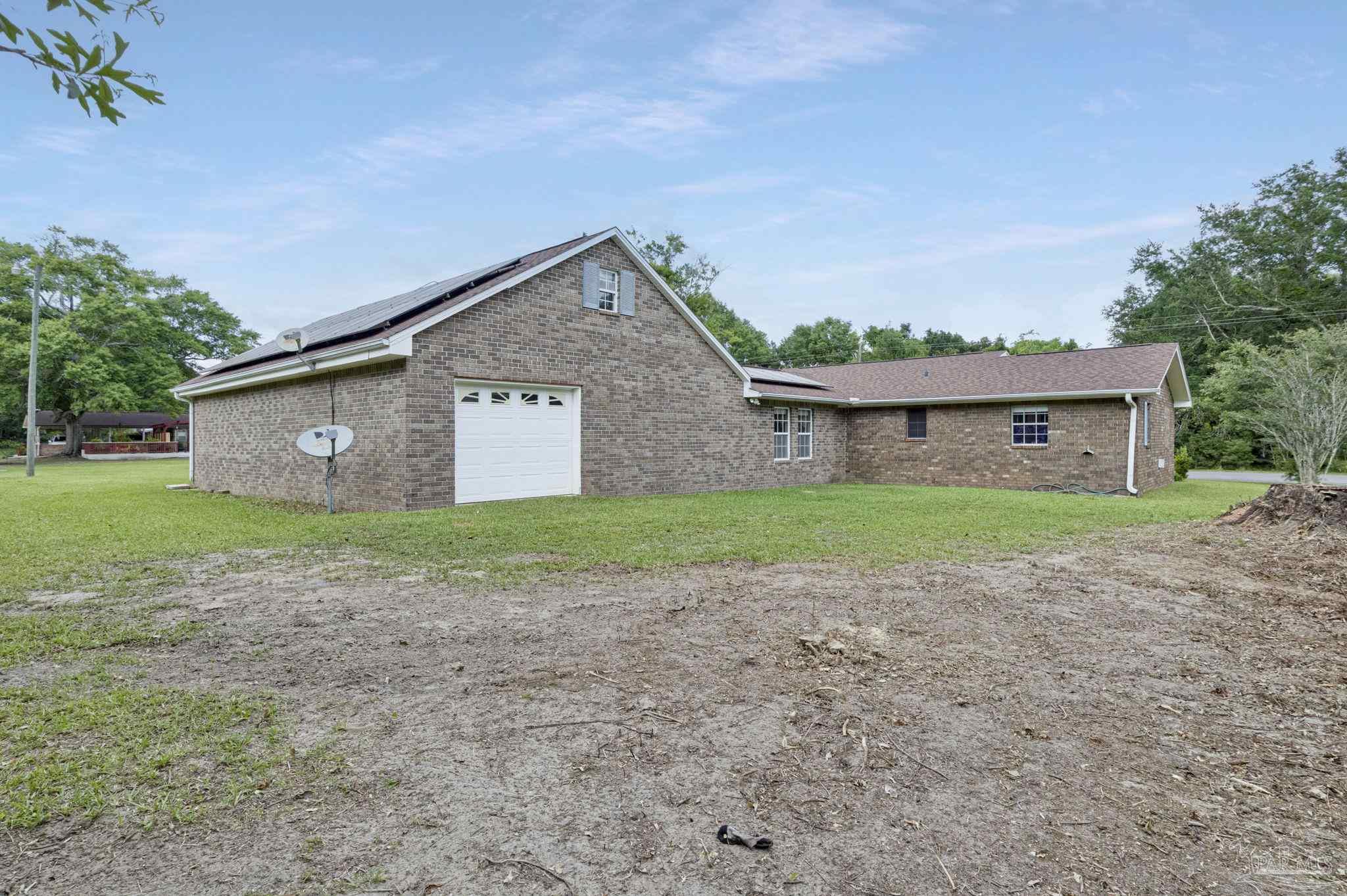 4411 Pace Lane Pace, FL 32571 - Photo 10 of 68 a front view of house with a garden