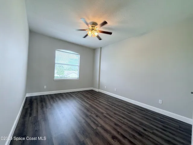 a bedroom with a bed and a potted plant