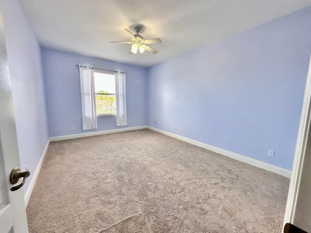 a bathroom with a granite countertop shower and a toilet