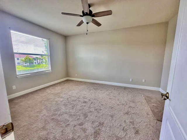 a view of a house next to a lake with a big yard