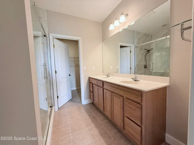 a front view of a house with a garden and trees