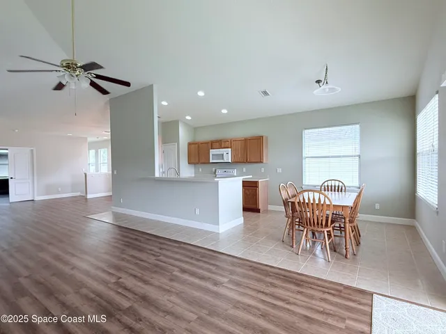 a kitchen with granite countertop white cabinets and stainless steel appliances