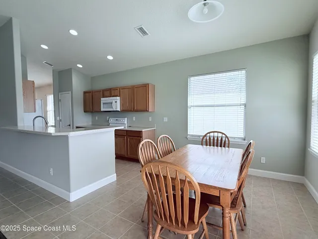 a kitchen with stainless steel appliances granite countertop a stove and a microwave with cabinets