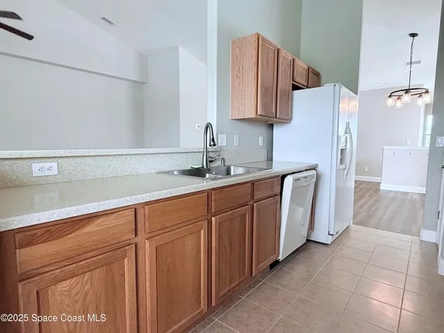 a kitchen with stainless steel appliances granite countertop a sink stove and microwave