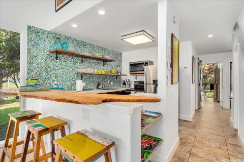 a kitchen with stainless steel appliances granite countertop a sink and cabinets