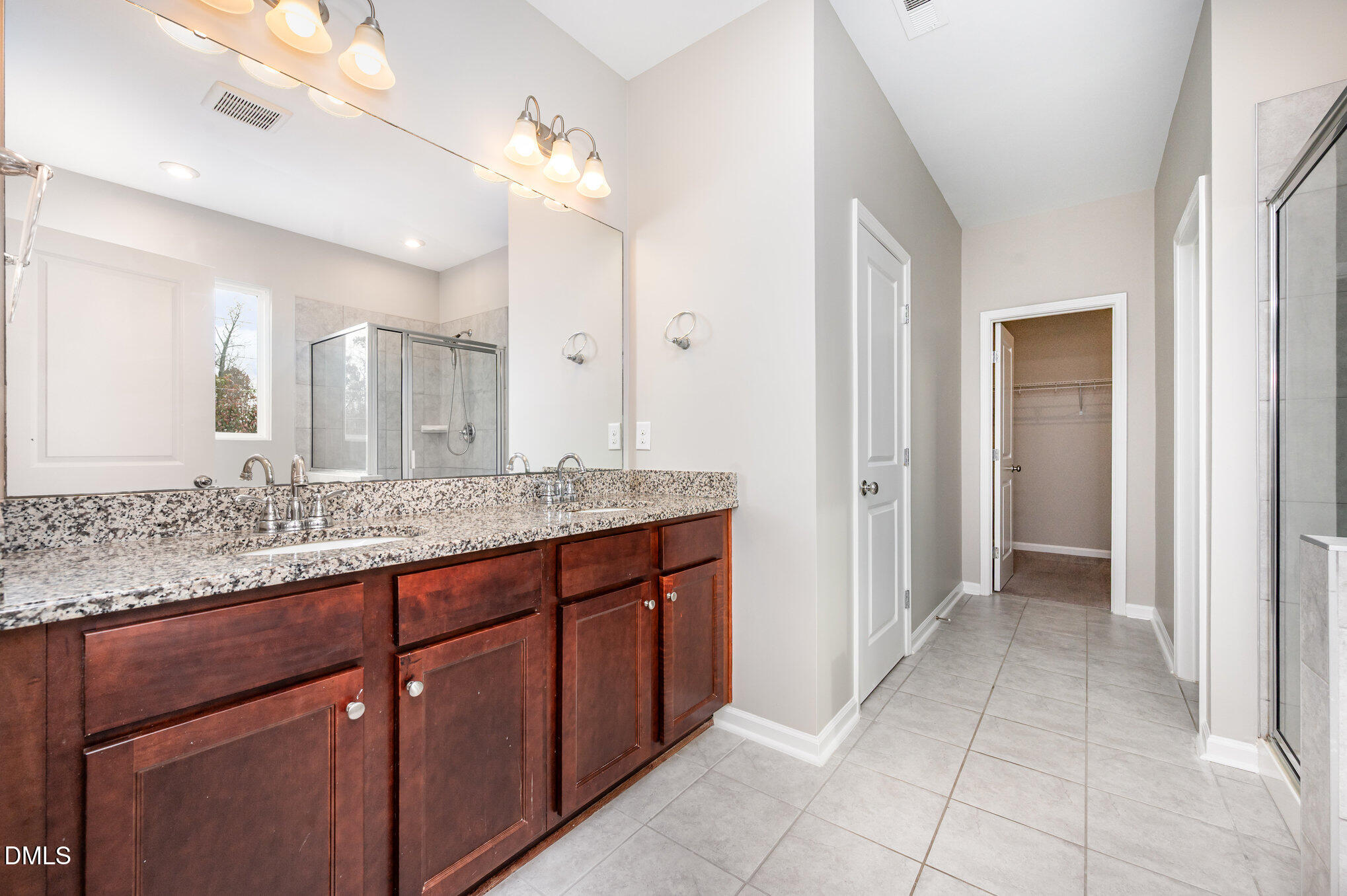 18 Dover Ridge Court Chapel Hill, NC 27517 - Photo 24 of 40 a bathroom with a granite countertop sink and a mirror