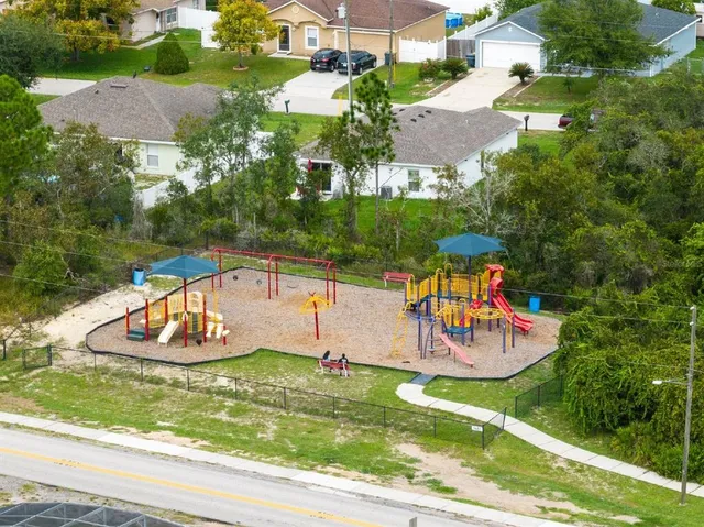 an aerial view of a swimming pool with a yard