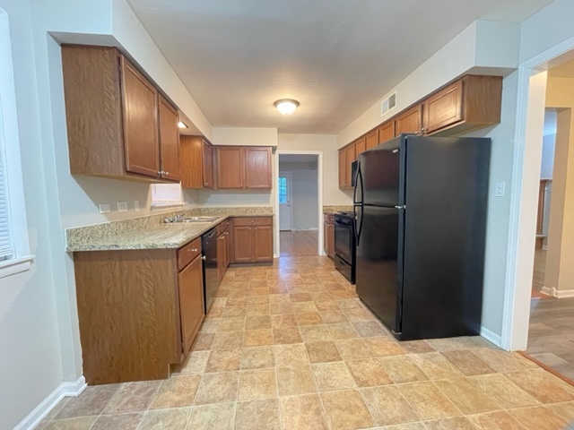 1424 Willow Road Homewood, IL 60430 - Photo 2 of 17 a kitchen with stainless steel appliances granite countertop a refrigerator and a sink