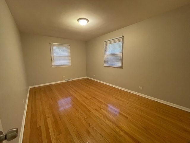 1424 Willow Road Homewood, IL 60430 - Photo 4 of 17 a view of empty room with wooden floor and fan