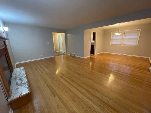 1424 Willow Road Homewood, IL 60430 - Photo 8 of 17 a view of an empty room with wooden floor and a window