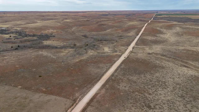a view of a field with an ocean view