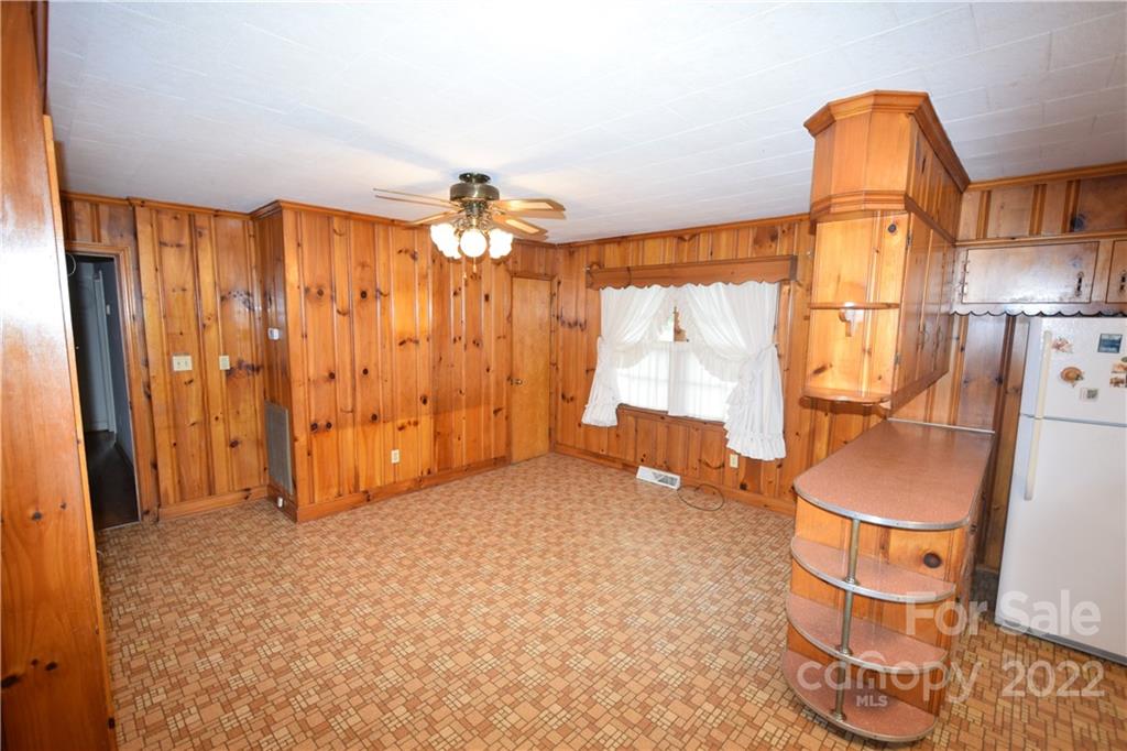 1095 Old Stonecutter Road Rutherfordton, NC 28139 - Photo 9 of 44 a view of an empty room with wooden floor and fan
